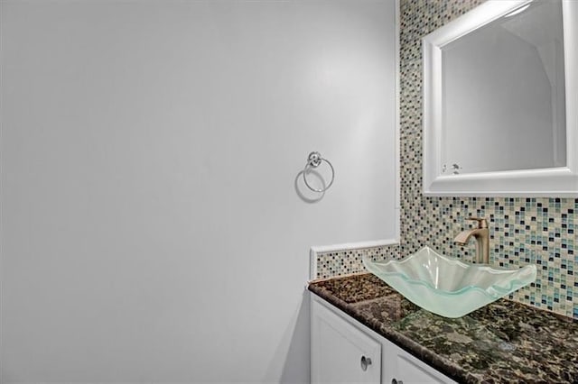 bathroom with tasteful backsplash and vanity