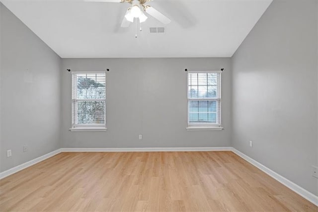 empty room featuring visible vents, baseboards, light wood-style floors, and a healthy amount of sunlight