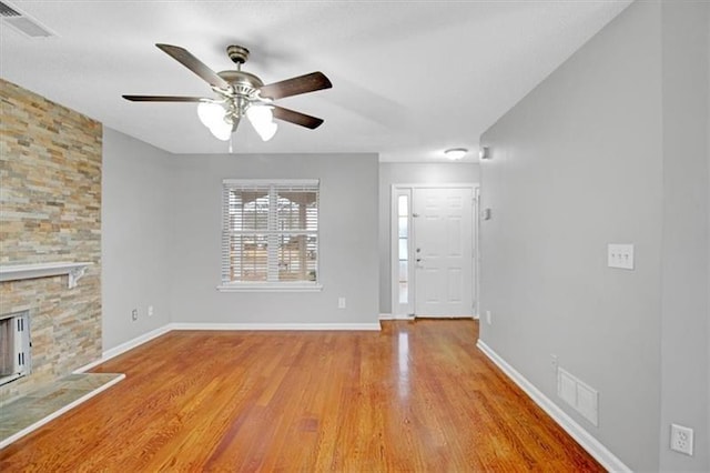 foyer entrance featuring wood finished floors, visible vents, and baseboards