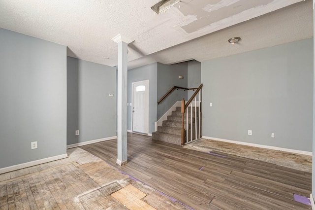 interior space with wood-type flooring and a textured ceiling