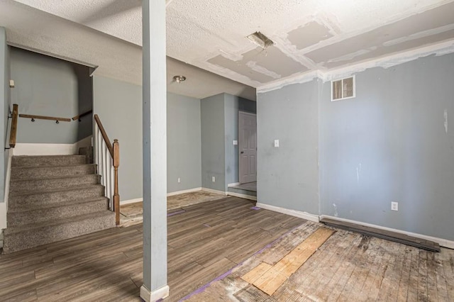 interior space featuring hardwood / wood-style flooring and a textured ceiling