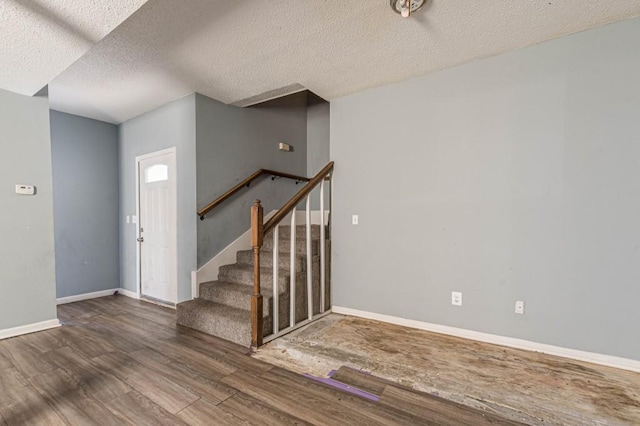 foyer with hardwood / wood-style floors and a textured ceiling