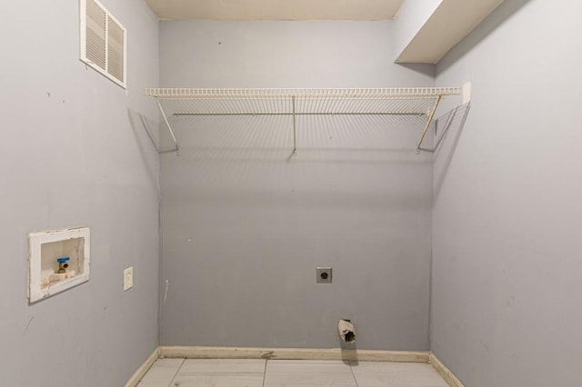 washroom with hookup for an electric dryer, hookup for a washing machine, and light tile patterned flooring