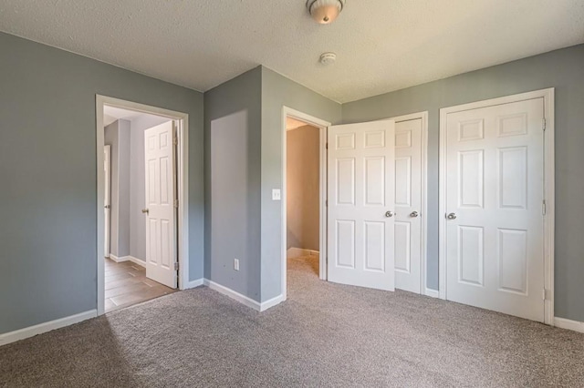 unfurnished bedroom with carpet and a textured ceiling