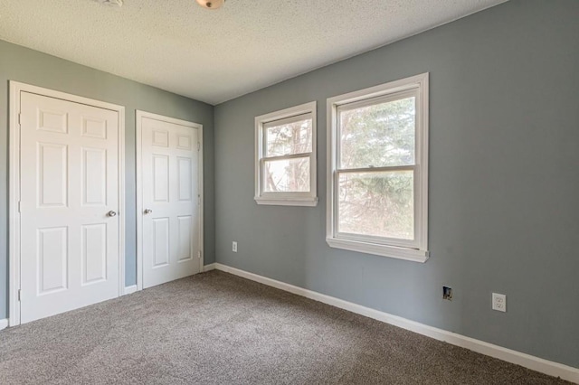 unfurnished bedroom with carpet flooring and a textured ceiling