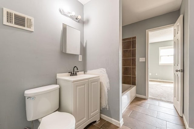 full bathroom with tile patterned floors, vanity, tub / shower combination, and toilet