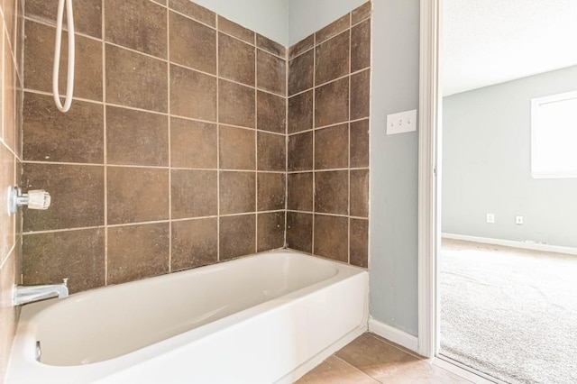 bathroom with tile patterned floors and washtub / shower combination