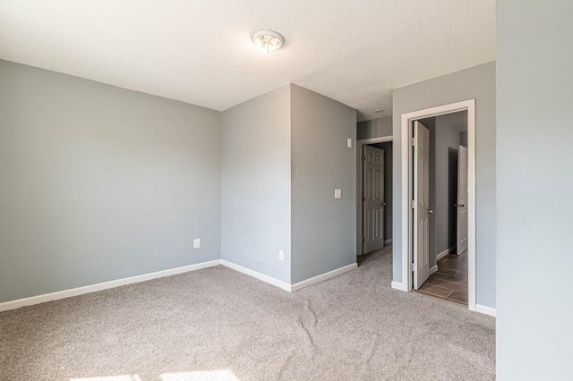 spare room with carpet and a textured ceiling