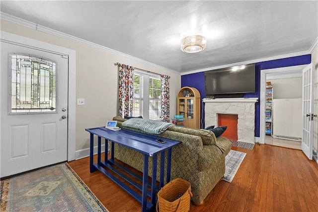 511 Robinson Ave SE, Atlanta, GA 30315 - living area with wood finished floors, crown molding, baseboards, a fireplace, and baseboard heating