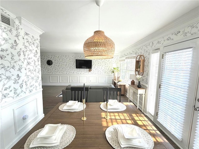 dining room featuring dark hardwood / wood-style flooring and ornamental molding