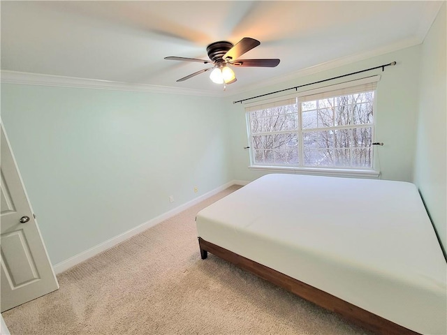 bedroom featuring ceiling fan, light carpet, and crown molding