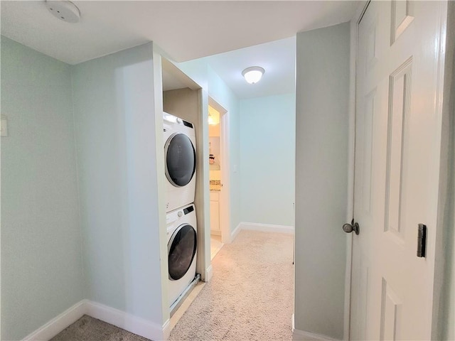 washroom with light carpet and stacked washer and dryer