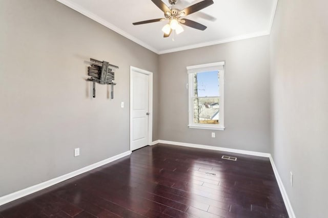 spare room with ornamental molding, dark hardwood / wood-style floors, and ceiling fan