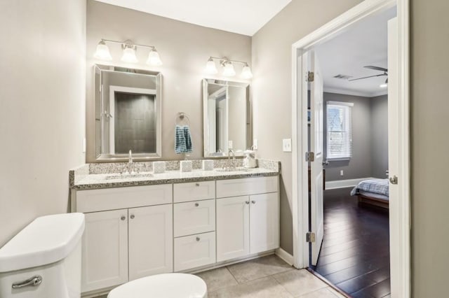 bathroom featuring vanity, toilet, and tile patterned flooring