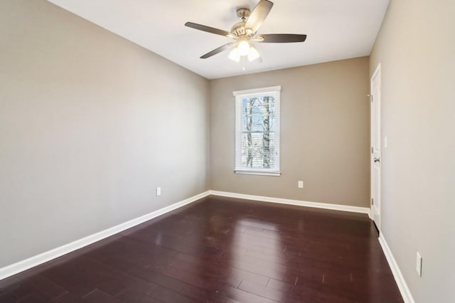 empty room with dark hardwood / wood-style floors and ceiling fan