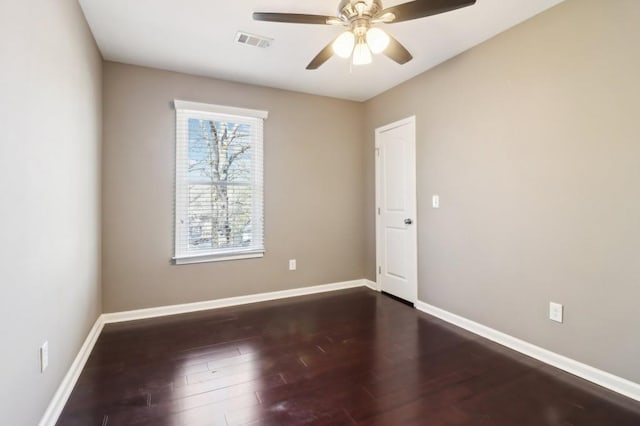 spare room featuring dark hardwood / wood-style floors and ceiling fan