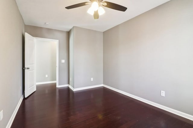 spare room featuring ceiling fan and dark hardwood / wood-style floors