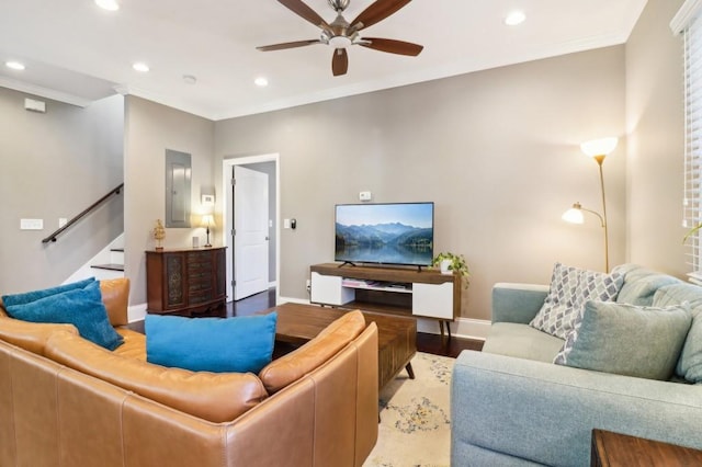 living room with crown molding, ceiling fan, electric panel, and hardwood / wood-style flooring