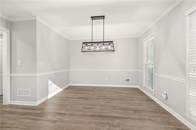 unfurnished dining area with hardwood / wood-style floors and ornamental molding