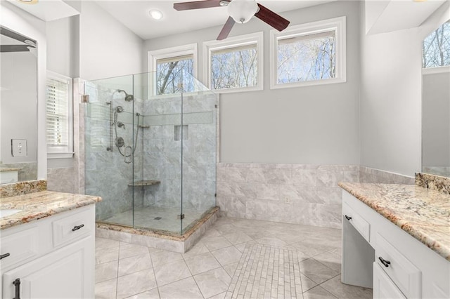 bathroom with tile patterned flooring, an enclosed shower, ceiling fan, and vanity