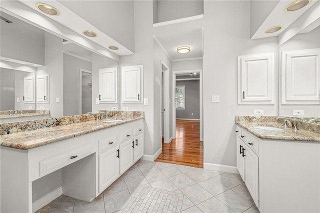 bathroom featuring vanity, crown molding, and tile patterned floors