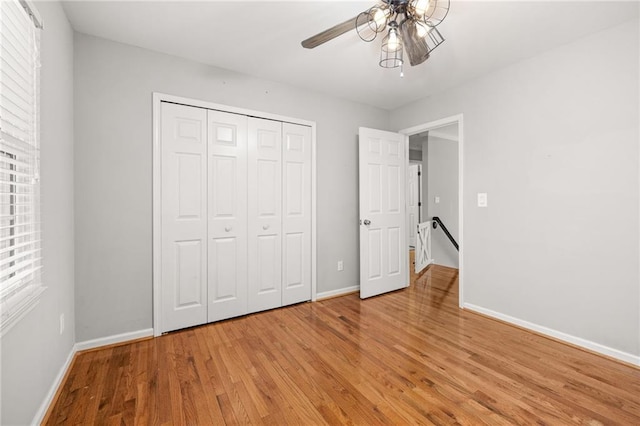 unfurnished bedroom featuring a closet, ceiling fan, and light hardwood / wood-style flooring