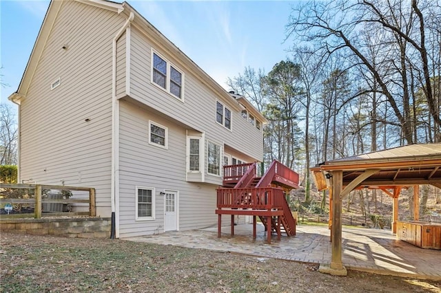 rear view of property with a gazebo and a patio