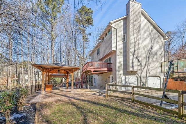 rear view of house with a deck and a patio