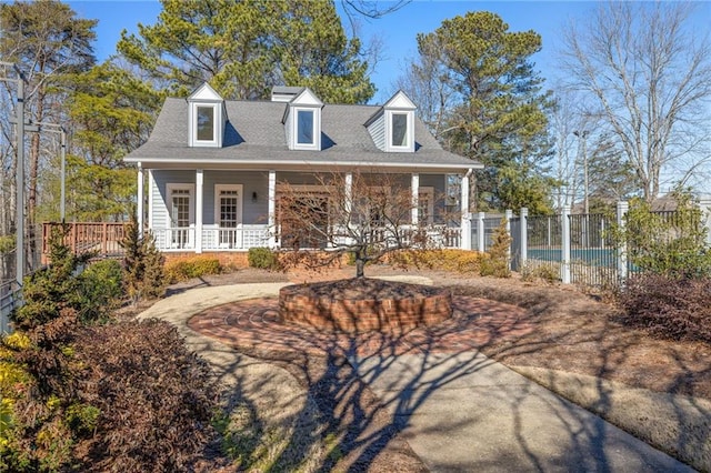 new england style home with covered porch