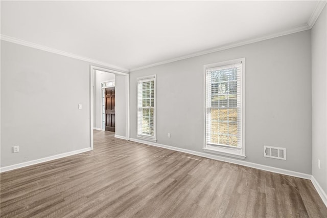 empty room featuring crown molding