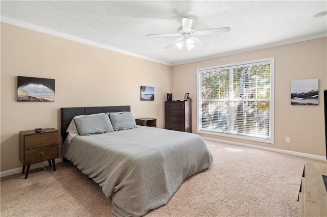 carpeted bedroom with ornamental molding and ceiling fan