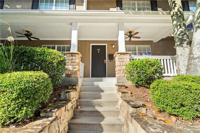 doorway to property with ceiling fan