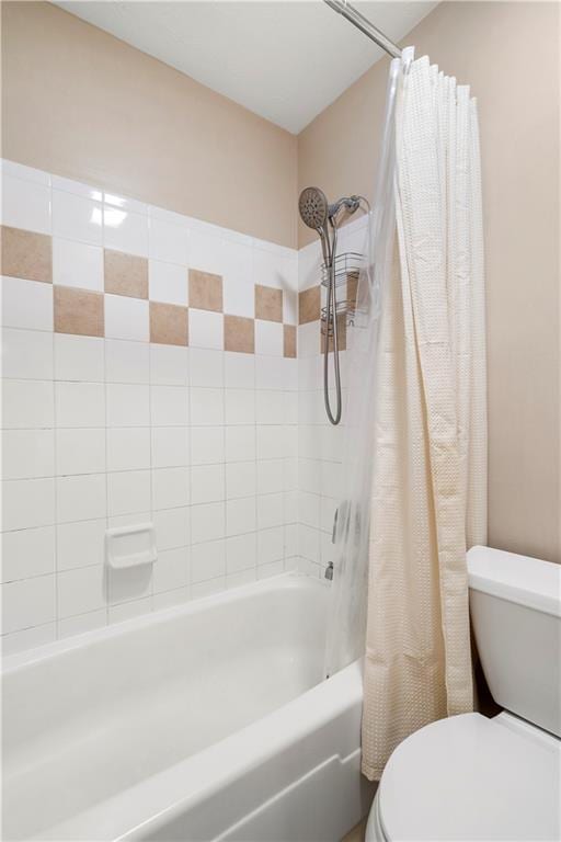 bathroom featuring shower / bath combo and toilet