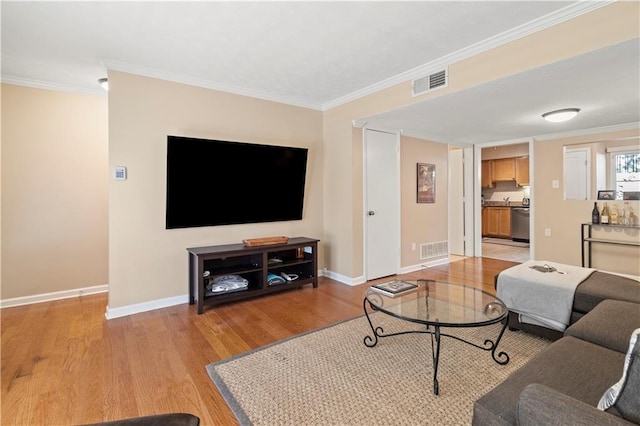 living room featuring crown molding and light wood-type flooring