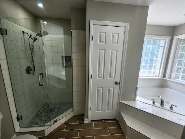 bathroom featuring independent shower and bath, toilet, and tile floors