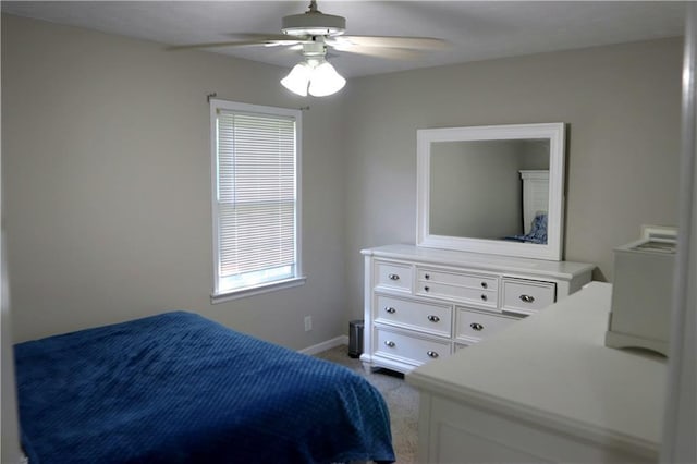 bedroom with ceiling fan and light carpet