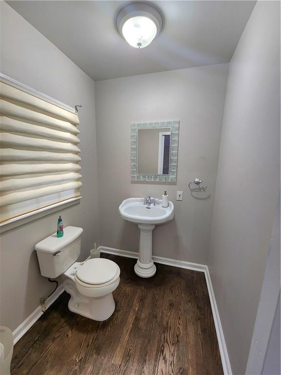 bathroom with toilet and hardwood / wood-style floors