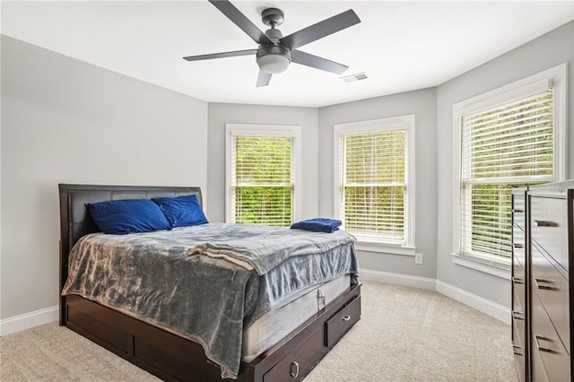 bedroom featuring baseboards, light carpet, and ceiling fan