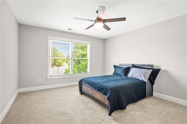 bedroom featuring baseboards, carpet floors, and a ceiling fan