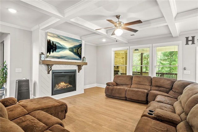 living room with light wood-style flooring, coffered ceiling, beam ceiling, ceiling fan, and a fireplace
