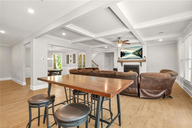 dining space with a lit fireplace, light wood-type flooring, stairs, recessed lighting, and ceiling fan