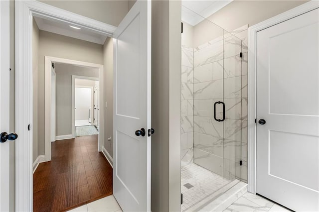 bathroom with an enclosed shower and hardwood / wood-style floors