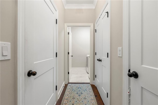 hallway with separate washer and dryer and dark hardwood / wood-style floors