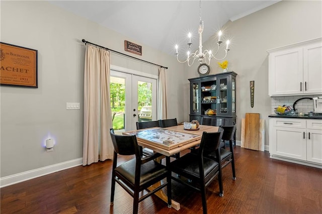 dining room with lofted ceiling, an inviting chandelier, and dark hardwood / wood-style flooring