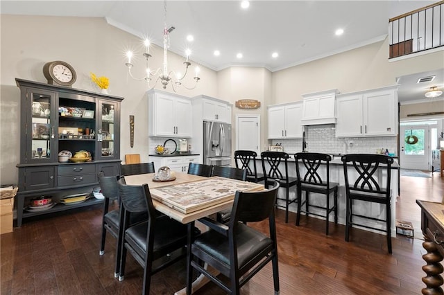 dining room with high vaulted ceiling, ornamental molding, a chandelier, and dark hardwood / wood-style floors