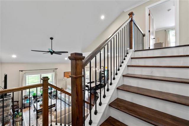 staircase with lofted ceiling and ceiling fan