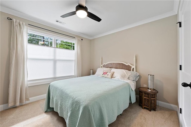 bedroom with ceiling fan, light carpet, and ornamental molding