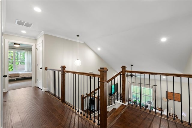 stairway with hardwood / wood-style flooring, vaulted ceiling, and ornamental molding