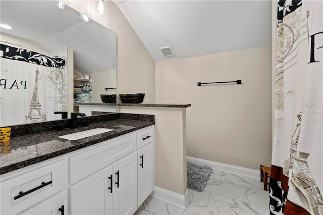 bathroom featuring vanity, lofted ceiling, and a shower with shower curtain