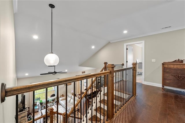 corridor featuring dark hardwood / wood-style floors, crown molding, and vaulted ceiling